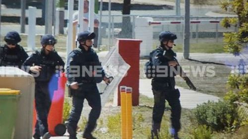 Police at the scene of the riot. (9NEWS)