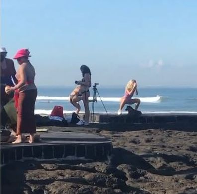 Influencer practises squat routine in Bali to no one's amusement.