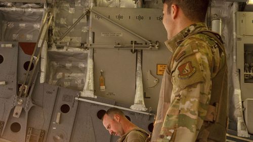 US Army Reserve, U.S. Airmen check their manifest for military equipment to be loaded onto a cargo plane as part of the deliberate withdrawal of forces from northern Syria at the Kobani Landing Zone. 