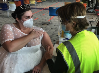 Sarah Study got the coronavirus vaccine in her wedding reception gown