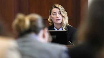 Actor Johnny Depp, left, listens as actor Amber Heard testifies in the courtroom at the Fairfax County Circuit Court in Fairfax, Va.