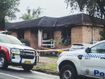 Three children have died and a man is in police custody after a house fire in Lalor Park.