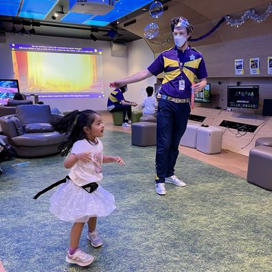 Priya Patel dances with a Starlight Captain in the Starlight Express Room.