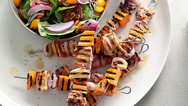 Maple-glazed chicken and kumara skewers with spinach pecan salad