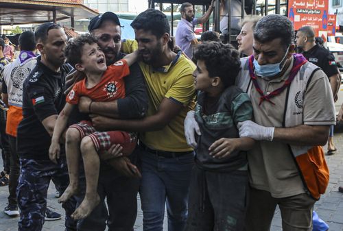 Wounded Palestinian children arrive to al-Shifa hospital, following Israeli airstrikes on Gaza City, central Gaza Strip, Tuesday, Oct. 17, 2023. 