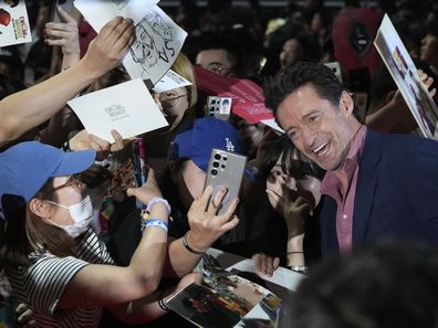 Actor Hugh Jackman poses for photos with fans during the red carpet event to promote his latest movie "Deadpool & Wolverine" in Seoul, South Korea, Thursday, July 4, 2024. 