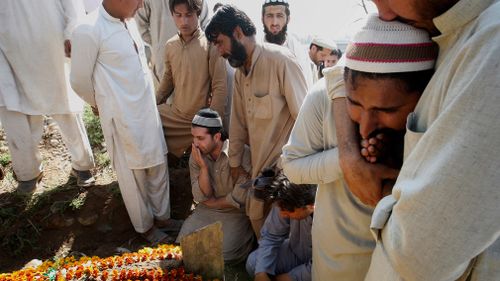 Pakistani villagers and family members mourn during the funeral of  lawyer Samiullah Khan Afridi, who was killed months after he announced that he would no longer be representing Dr Shakil Afridi. (AAP)