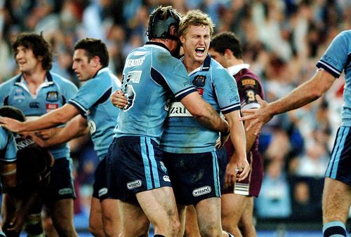 Brett Finch gets mobbed by teammates after landing a field goal to win Game I in 2006.