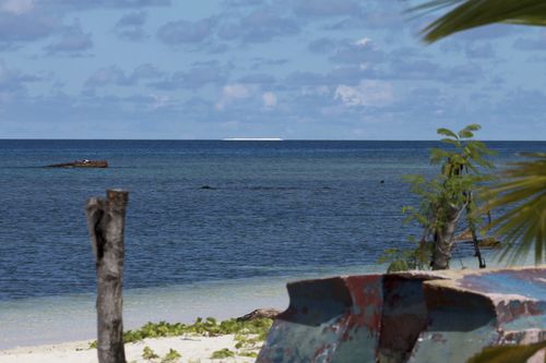 In photo, a sandbar, sits on the horizon off the Philippine-claimed Thitu Island in the disputed South China Sea in western Philippines, April 21, 2017.