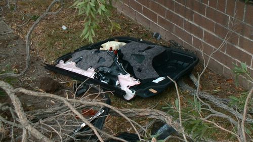 Debris and car parts at the scene of the crash in south-west Sydney. (9NEWS)