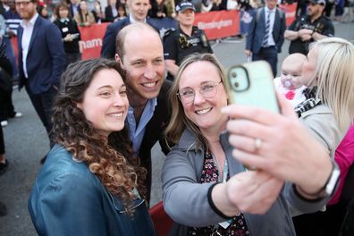 Prince William takes selfies with members of the public after leaving The Rectory during their visit to Birmingham on April 20, 2023 in Birmingham, England.