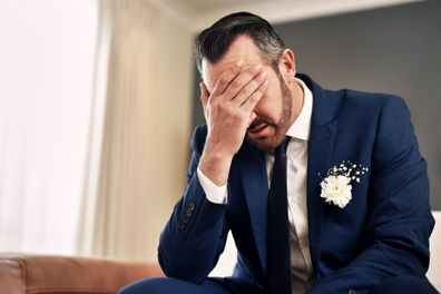 Shot of a handsome mature bridegroom looking stressed and suffering from a headache on his wedding day