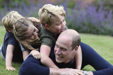 George plays with his dad and siblings at the family home.