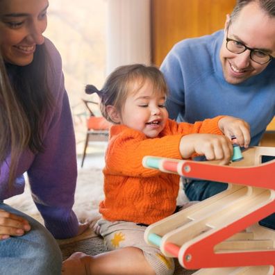 Parents playing with child. 