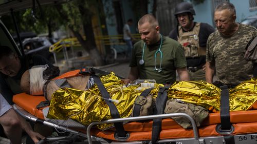 An injured Ukrainian serviceman is evacuated to a hospital in the Donetsk oblast region, eastern Ukraine, Sunday, June 5, 2022. (AP Photo/Bernat Armangue)