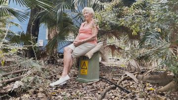 Fellow resident Jan Pitt camped out on her electricity box to stop her lights being turned off.
