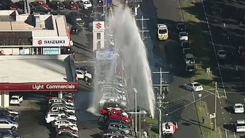 Water floods Melbourne dealership after car crashes into hydrant
