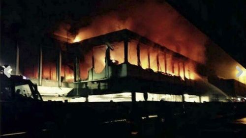 Flames rise from Rome's Fiumicino airport main international terminal. (AAP)