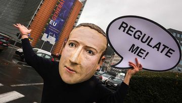 A campaigner from the global citizens movement Avaaz wearing a mask of Facebook CEO Mark Zuckerberg.