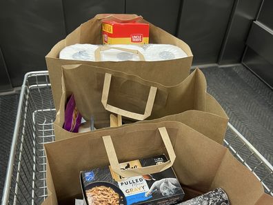 shopping bags at supermarket groceries coles woolworths aldi 