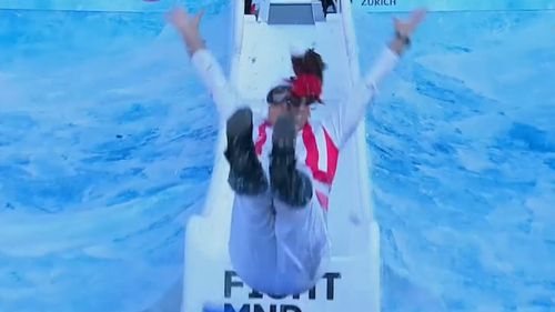 Sydney Swans coach John "Horse" Longmire looked "giddy" as he slid into the icy water below. (9NEWS)