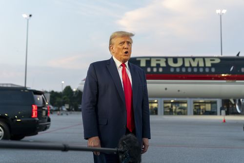 Former President Donald Trump speaks with reporters before departure from Hartsfield-Jackson Atlanta International Airport, Thursday, Aug. 24, 2023, in Atlanta. 