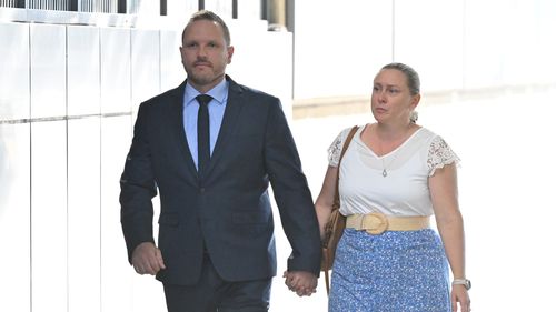 Daniel Lindquist appeared with his wife at court where he's denied sexually touching two sisters.