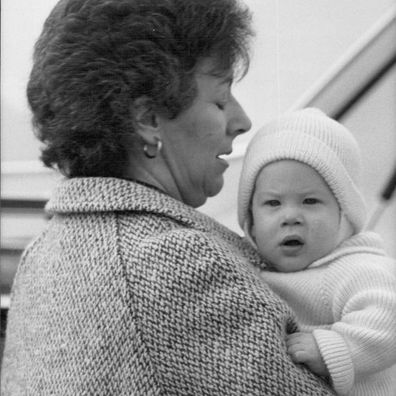 Prince Harry, pictured at Aberdeen airport yesterday being carried up the steps of the plane by Nanny Barbara Barnes March 25, 1985.