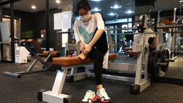 A woman works out at Chungwoon Sporex gym in Seoul, South Korea, where new restrictions have been imposed in gyms.