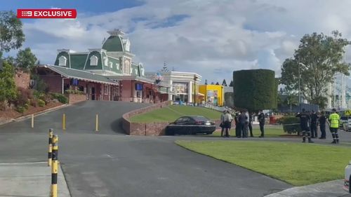 A hammer attack and car crash have unfolded at the entrance to Dreamworld.