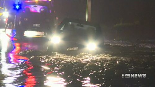 Cars were caught in floodwaters as heavy rain lashed south east Queensland. (9NEWS)