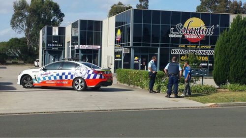 Police at the scene of the suspected armed robbery. (Supplied)