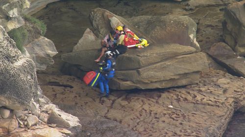 A man has been winched to safety after his boat capsized in rough sea in Sydney's south.