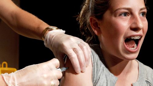 Sophie Weisz, aged 14, reacts when injected with Gardasil, the world's first cervical cancer vaccine in Sydneyon August 28, 2006. (AAP)