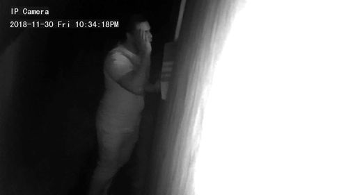 Police have released images of a man after a camera captured him peeping through the window of a house.