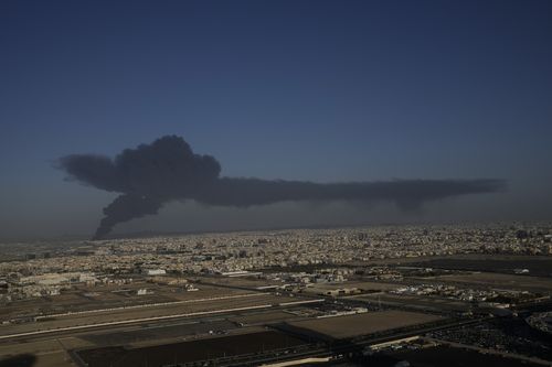 A cloud of smoke rises from a burning oil depot  in Jiddah, Saudi Arabia, Friday, March 25, 2022 
