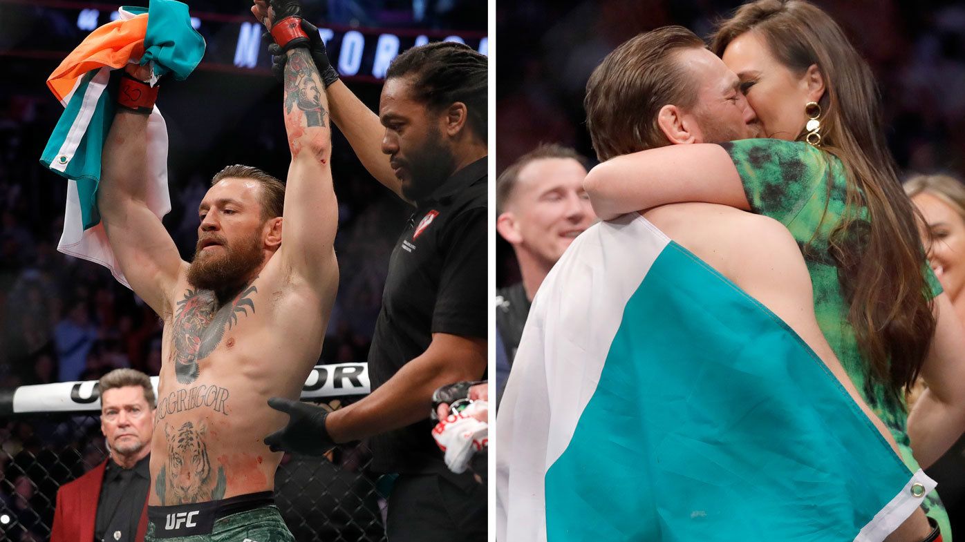 Conor McGregor kisses Dee Devlin after his first round TKO victory against Donald Cerrone 