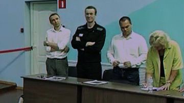 Russian opposition politician Alexei Navalny and his lawyers Olga Mikhailova, Vadim Kobzev and Alexander Fedulov appear on a screen via video link during an external hearing of the Moscow City Court in the criminal case against Navalny on numerous charges, including the creation of an extremist organization, at the IK-6 penal colony in Melekhovo in the Vladimir region, Russia, August 4, 2023. 