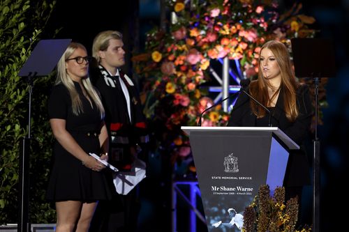 Summer Warne speaks on stage alongside Jackson Warne and Brooke Warne during the state memorial service for former Australian cricketer Shane Warne at the Melbourne Cricket Ground on March 30, 2022 in Melbourne, Australia. 