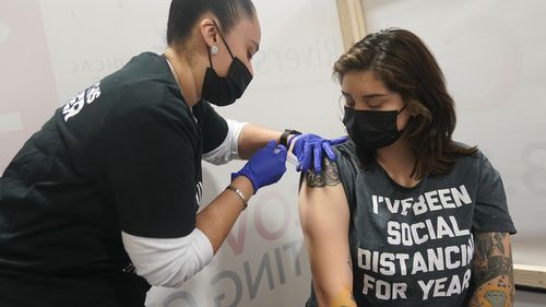 Denise Padilla, an instructor at the culinary school at Eva's Village, is vaccinated in Secacus, New Jersey.