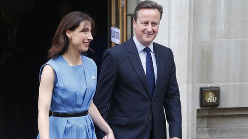 British MP David Cameron after voting with wife Samantha. (AAP)