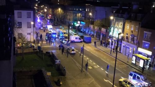 Four people injured and man arrested after car mounts London street