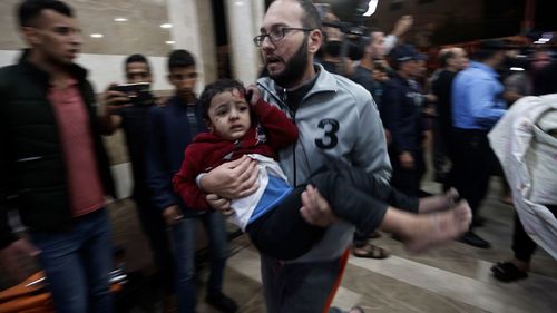 A wounded Palestinian child is carried into the Nasser Hospital following an Israeli bombardment on Khan Younis refugee camp, southern Gaza Strip.