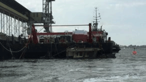 Water has to be pumped out of the Dianne before the trawler is lifted on to land. (Queensland Police Service)