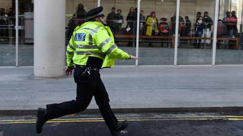 A British Transport Police officer runs along a street after reports of shots being fired on London Bridge on November 29, 2019