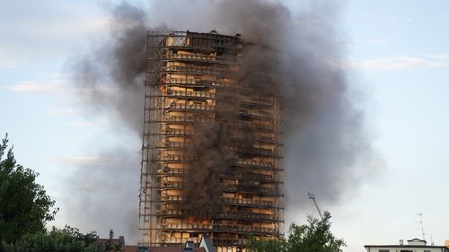 Smoke billows from a building in Milan. Firefighters were battling a blaze on Sunday that spread rapidly through a recently restructured 60-meter-high, 16-story residential building in Milan.