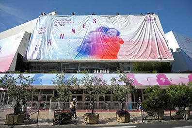 CANNES, FRANCE - MAY 11: Workers install the official festival poster at the Palais de Festival ahead of the 78th annual Cannes Film Festival at  on May 11, 2025 in Cannes, France. (Photo by Thomas Kronsteiner/Getty Images)