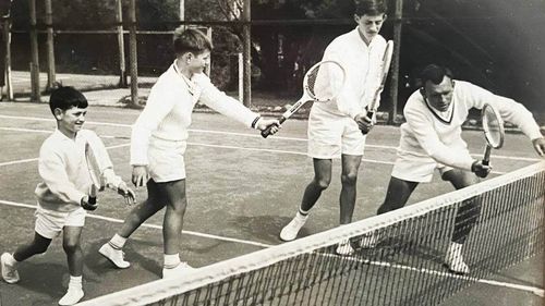 Left to right: Brothers Melvin, Tony and Onny Parun practising with coach Len Aitkens on the courts at Wadestown Primary School in 1964.