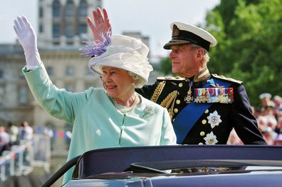 The Queen and the Duke of Edinburgh, Prince Philip, wave to the crowd as they leave  the "Recollections Of World War II Commemoration Show" in 2005