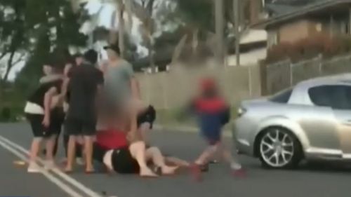 A boy was captured kicking the driver's car door. (9NEWS)